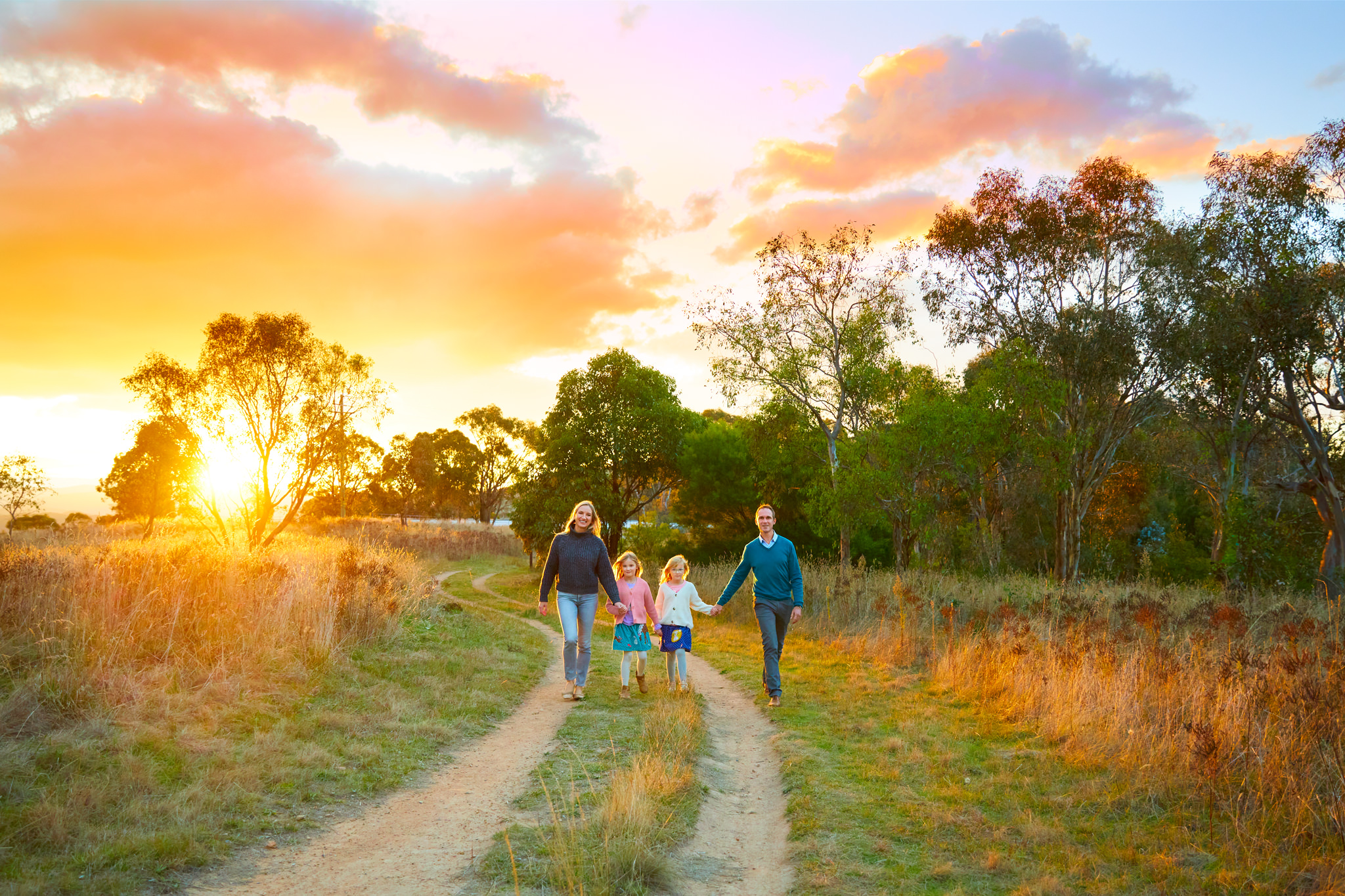 Family of four walking on a path in the Canberra bush