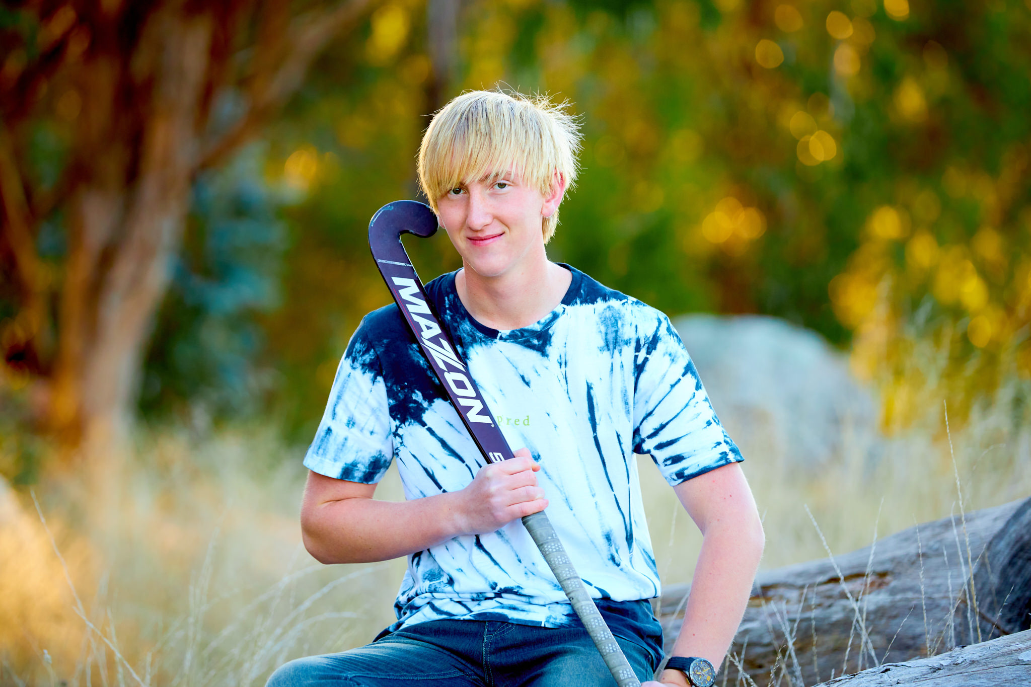 Portrait of teenager with a hockey stick in Canberra