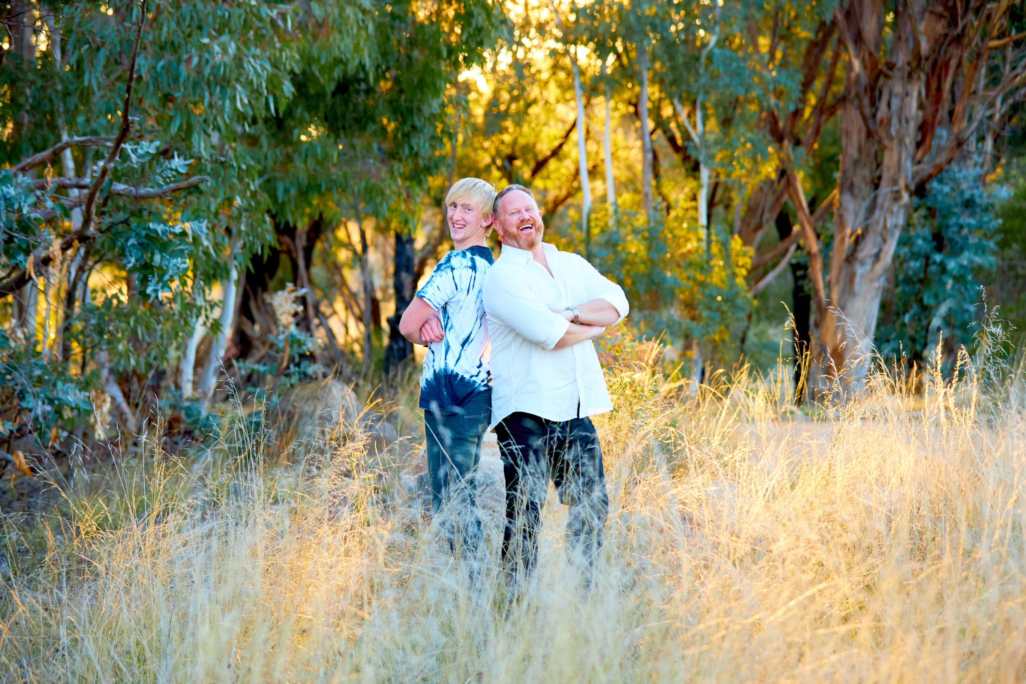 Father and son posing laughing in the Canberran bush